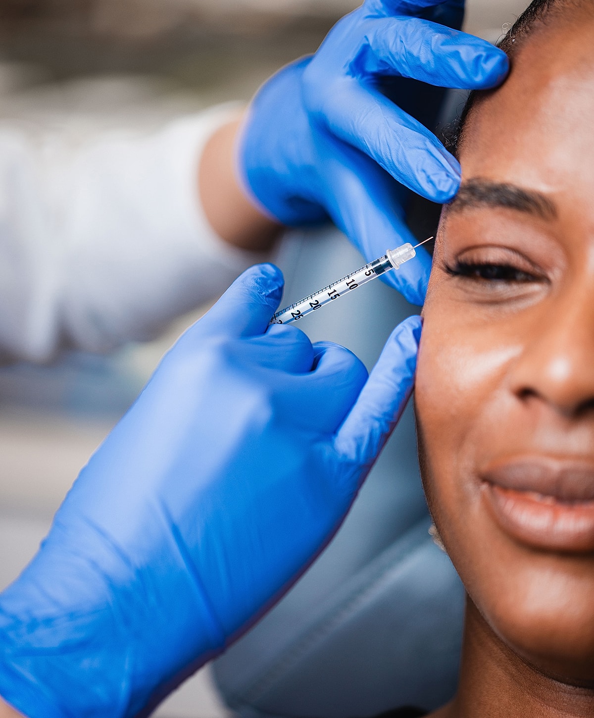 Administering cosmetic injection to a patient.