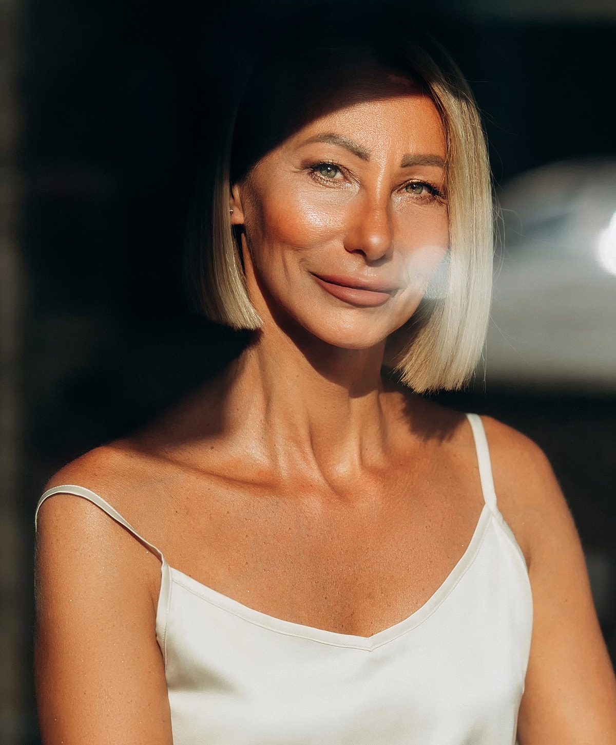 Woman with short hair in soft lighting.