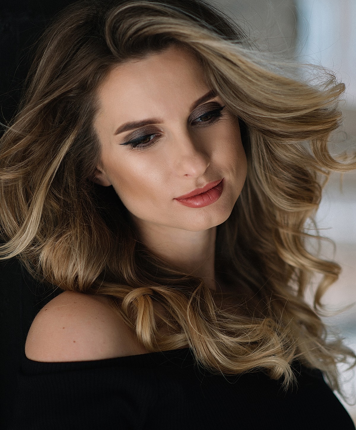 Close-up portrait of woman with wavy hair.