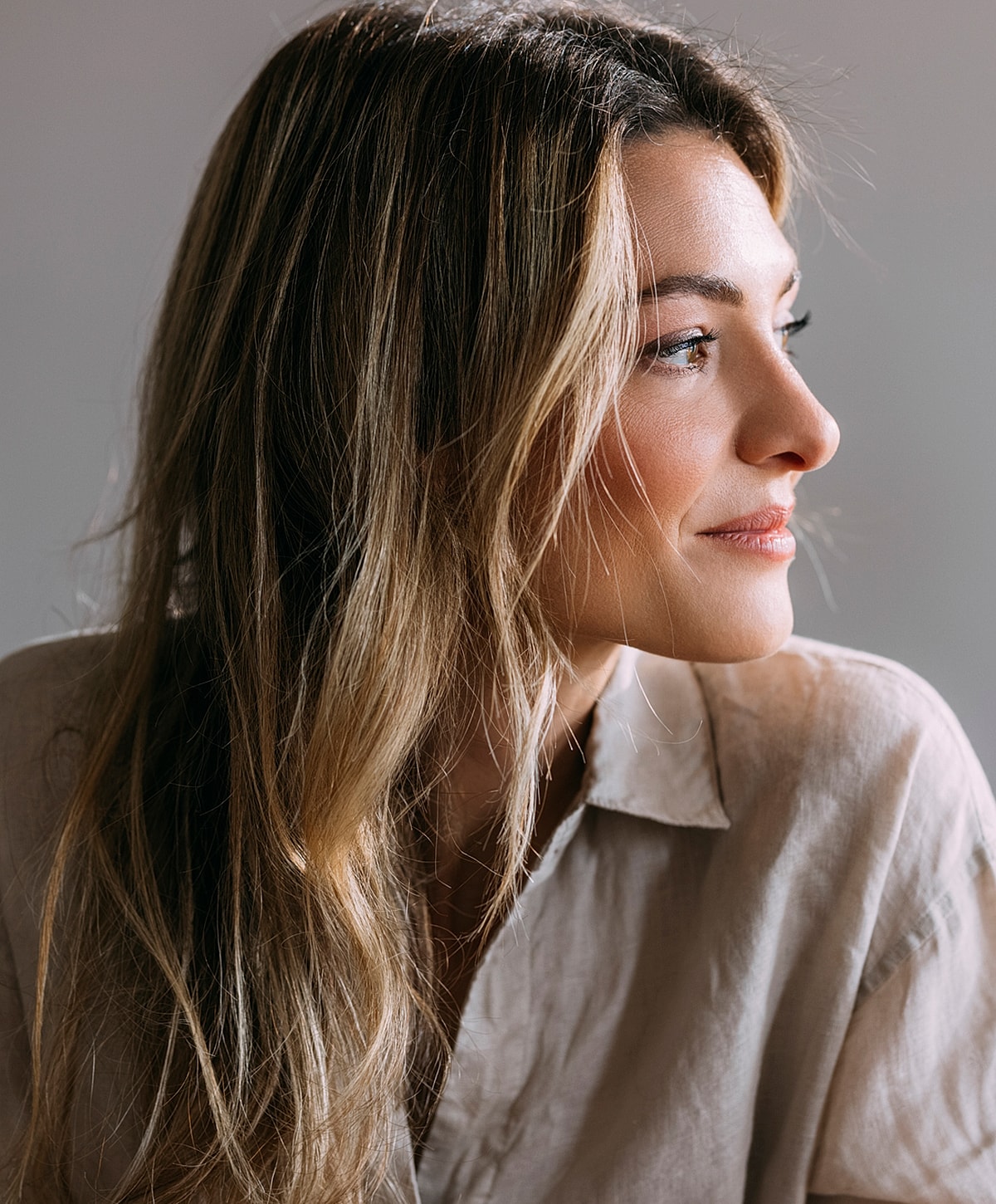 Woman with long hair in profile view.