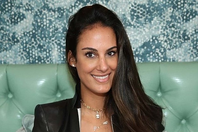 Smiling woman in a stylish setting.