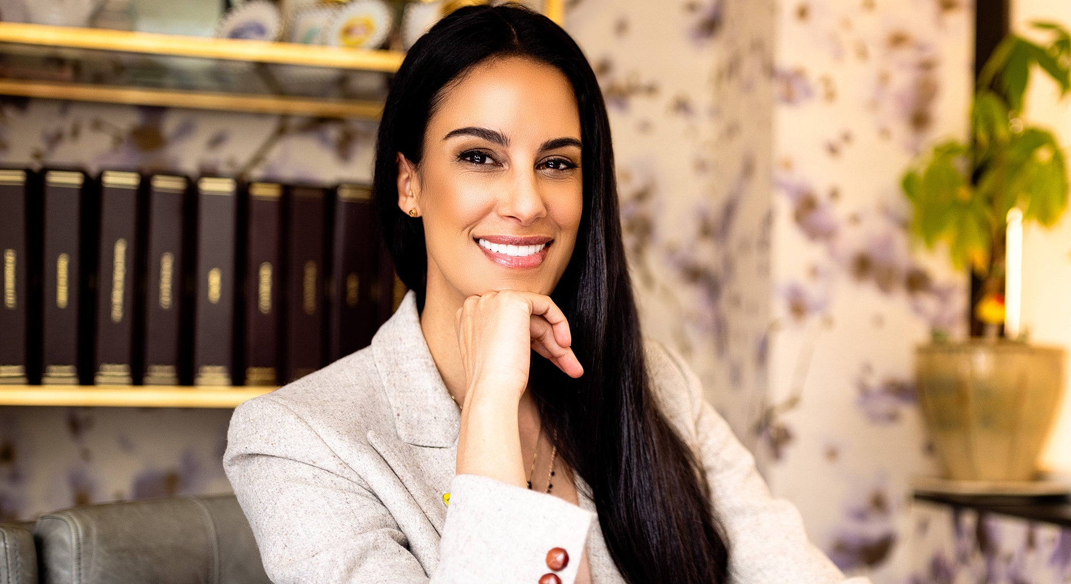 Smiling woman in professional attire indoors.