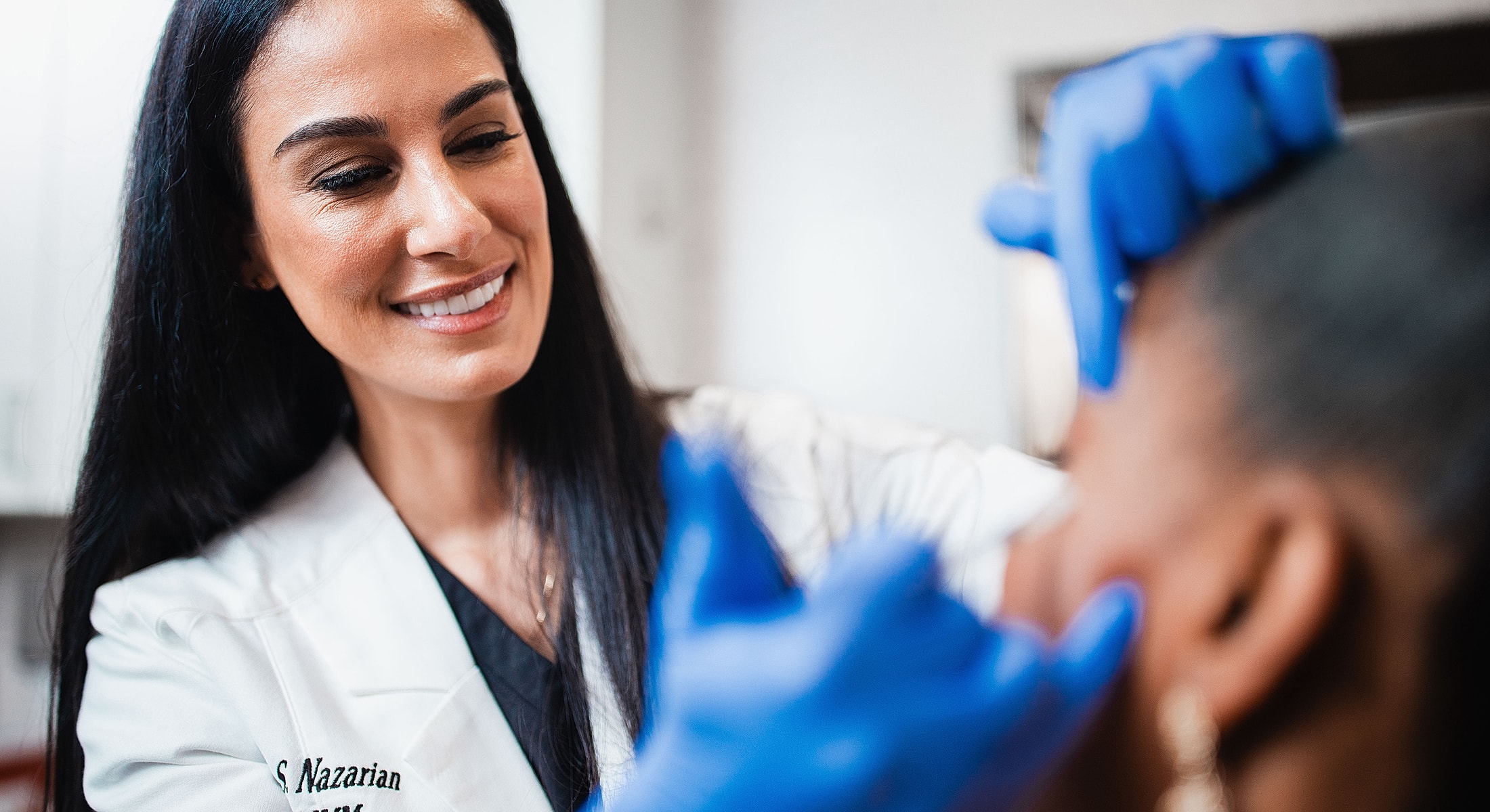 Medical professional examining a patient's skin.